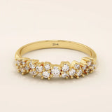 14k solid yellow gold band featuring clusters of round brilliant cut moissanite stones in prong settings, creating a textured and sparkling fine jewelry design for weddings or special occasions
