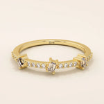 14k solid yellow gold band featuring three baguette cut moissanite stones spaced along a row of pavé set round moissanite accents, modern fine jewelry for weddings or stacking
