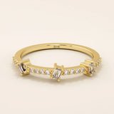 14k solid yellow gold band featuring three baguette cut moissanite stones spaced along a row of pavé set round moissanite accents, modern fine jewelry for weddings or stacking
