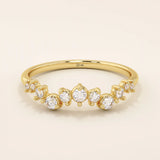 14k solid yellow gold band with alternating small and large round moissanite stones in a curved pavé setting.
