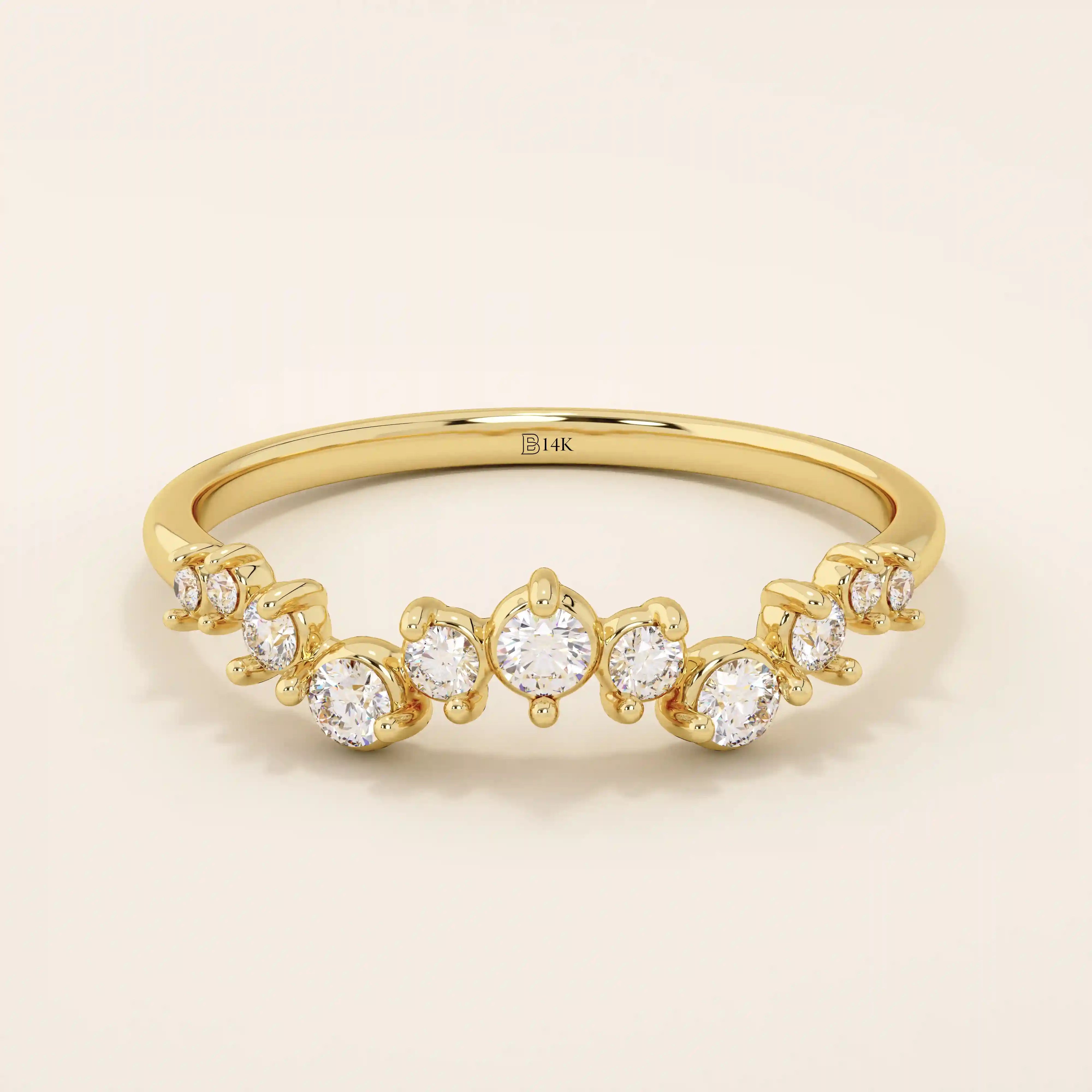 14k solid yellow gold band with alternating small and large round moissanite stones in a curved pavé setting.
