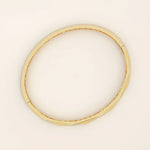 14k solid yellow gold bangle bracelet with a sleek faceted design, featuring geometric angled cuts that reflect light beautifully for a modern, sophisticated look.
