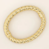 14k solid yellow gold bangle with a bold twisted rope design, featuring a high-polish finish and secure clasp closure for a luxurious, statement-making look.
