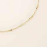 14k solid yellow gold bar chain bracelet featuring sleek horizontal bar links evenly spaced along a delicate gold chain, offering a modern and minimal aesthetic.
