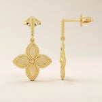 14k solid yellow gold dangle clover stud earrings featuring a twisted post and a four-petal clover drop with beaded edges.
