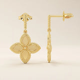 14k solid yellow gold dangle clover stud earrings featuring a twisted post and a four-petal clover drop with beaded edges.
