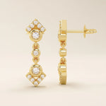 14k solid yellow gold dangling arrow stud earrings featuring bezel-set round moissanites and pavé arrowhead details.
