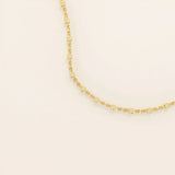 14k solid yellow gold dot chain necklace featuring small, evenly spaced flat square discs linked along a delicate chain, creating a sleek and modern everyday piece.
