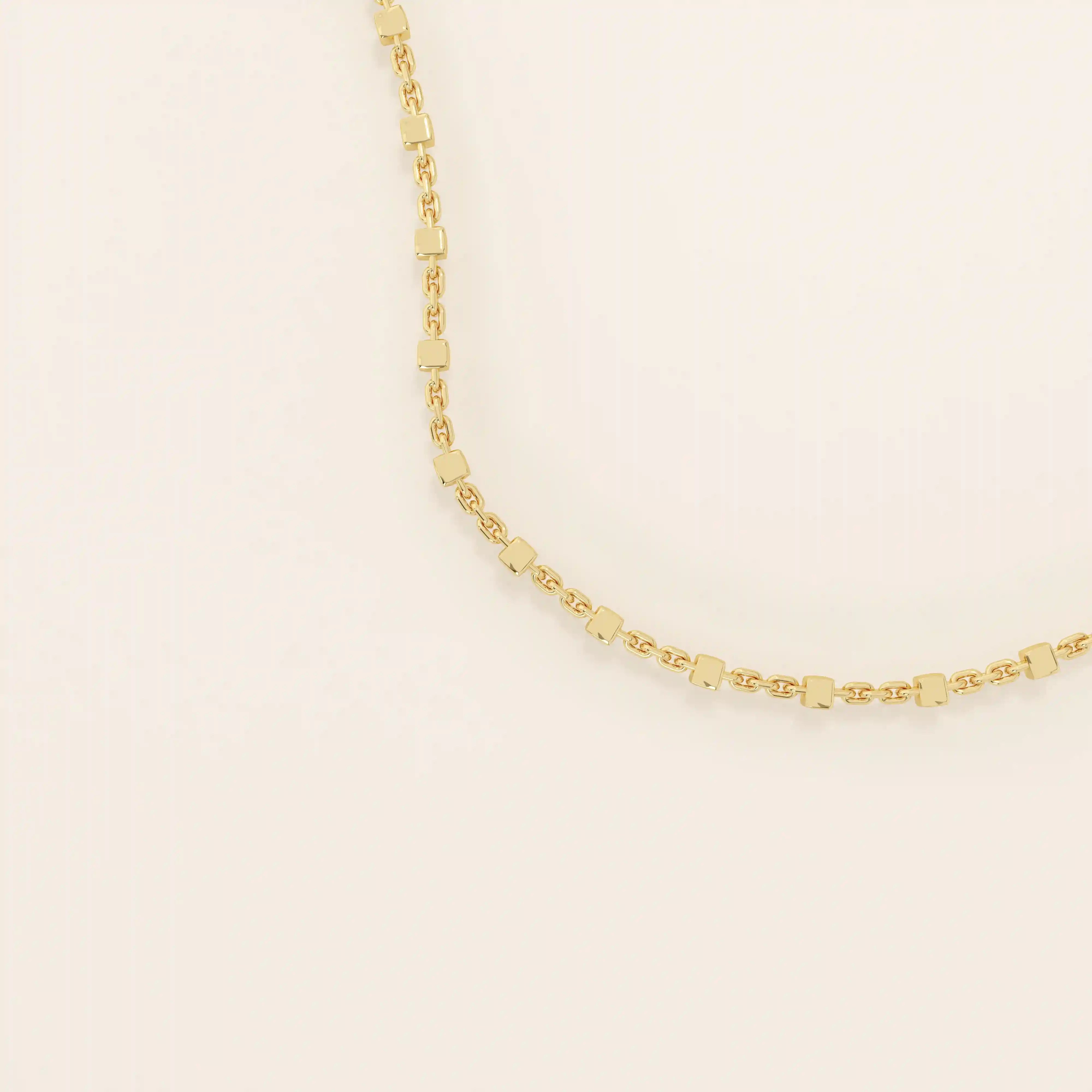 14k solid yellow gold dot chain necklace featuring small, evenly spaced flat square discs linked along a delicate chain, creating a sleek and modern everyday piece.
