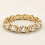14k solid yellow gold eternity band featuring sideways pear cut moissanite stones surrounded by pavé set round moissanite accents and intricate milgrain detailing, luxurious fine jewelry for weddings or anniversaries
