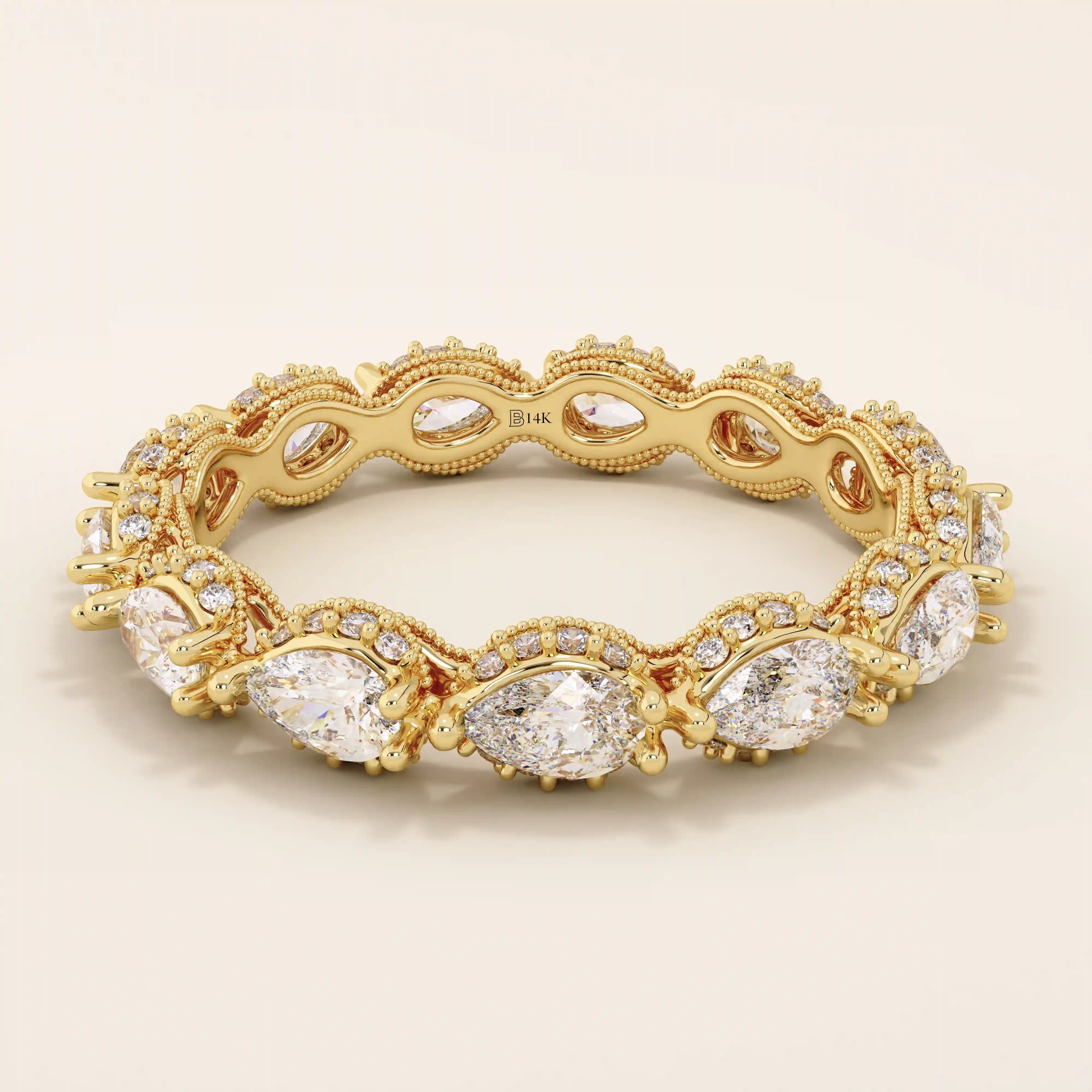 14k solid yellow gold eternity band featuring sideways pear cut moissanite stones surrounded by pavé set round moissanite accents and intricate milgrain detailing, luxurious fine jewelry for weddings or anniversaries
