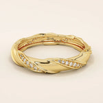 14k solid yellow gold eternity wedding band with a sculpted twist design, featuring rows of round brilliant-cut moissanites set all around
