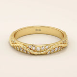 14k solid yellow gold eternity wedding band with intertwined twist design, set with round brilliant-cut moissanites all around
