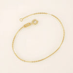 14k solid yellow gold flat bar chain bracelet featuring sleek rectangular links spaced along a delicate gold chain, offering a minimalist yet sophisticated style.
