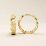 14k solid yellow gold hoop earrings with bold, interlocking hexagon links forming a continuous geometric design, polished to a mirror-like shine.
