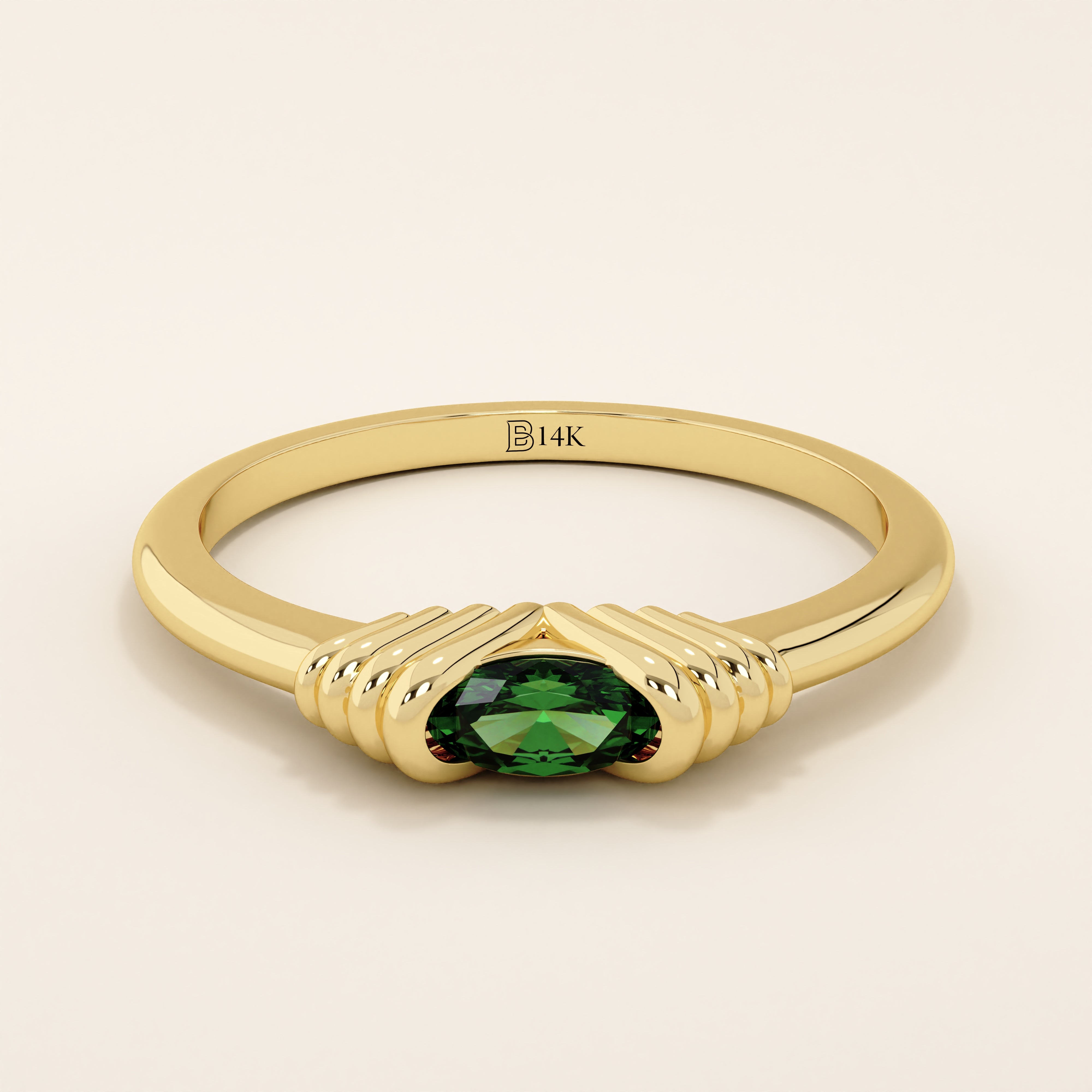 14k solid yellow gold ring featuring an oval-cut deep green gemstone held in a unique ribbed split setting.
