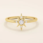 14k solid yellow gold ring with a starburst design, featuring a round moissanite center stone accented by four smaller moissanites.
