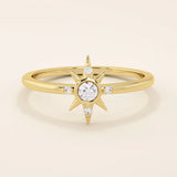 14k solid yellow gold ring with a starburst design, featuring a round moissanite center stone accented by four smaller moissanites.
