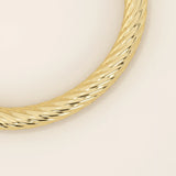 14k solid yellow gold rope bangle bracelet featuring a twisted rope texture, polished finish, and rounded edges.
