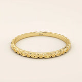 14k solid yellow gold slim wedding ring featuring a repeating marquise-shaped pattern around the band.

