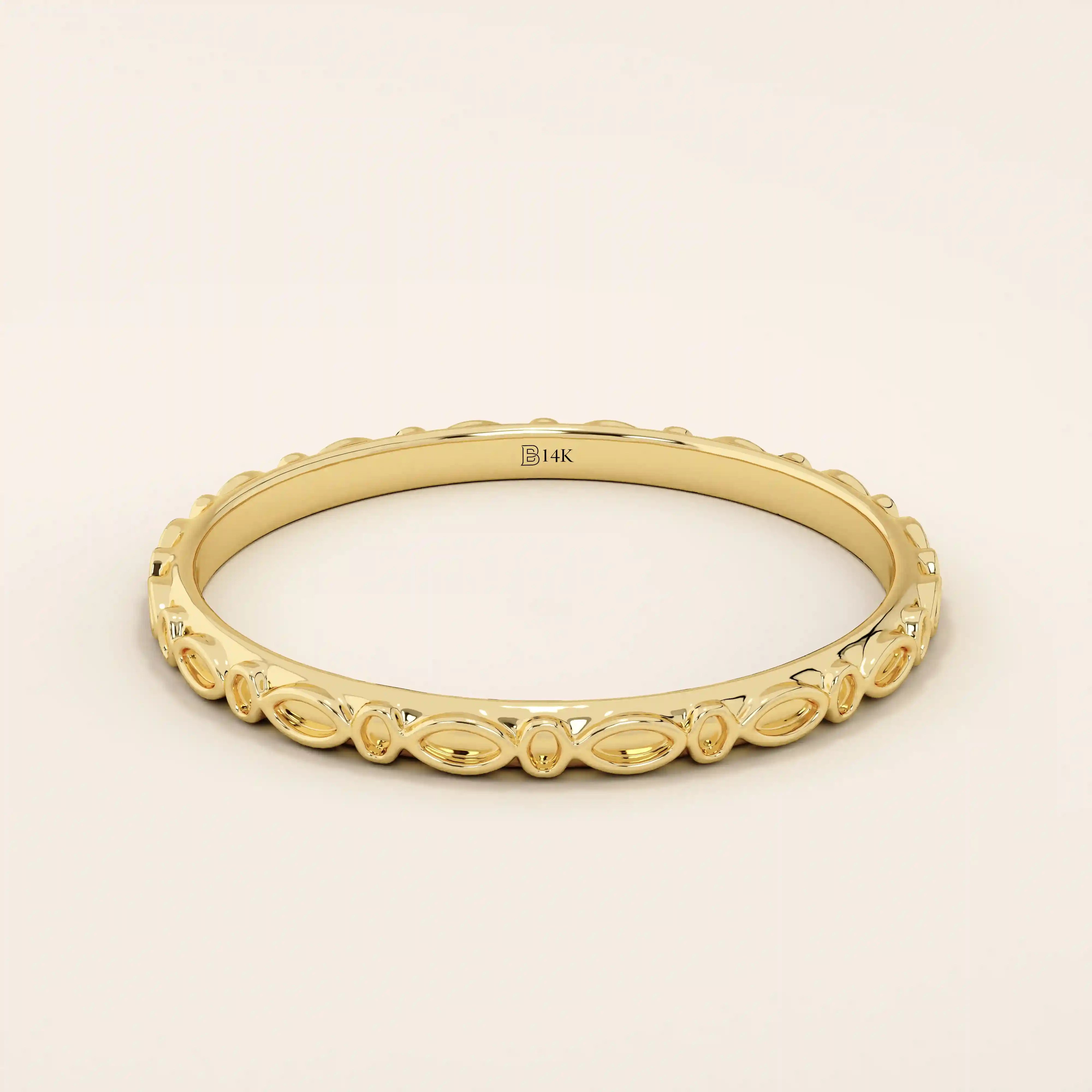 14k solid yellow gold slim wedding ring featuring a repeating marquise-shaped pattern around the band.
