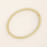 14k solid yellow gold textured square tube bangle bracelet with a slim polished band and subtle geometric detail.
