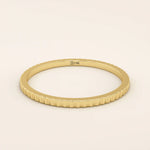 14k solid yellow gold thin stacking ring with a faceted textured design, minimalist fine jewelry for everyday wear or layering

