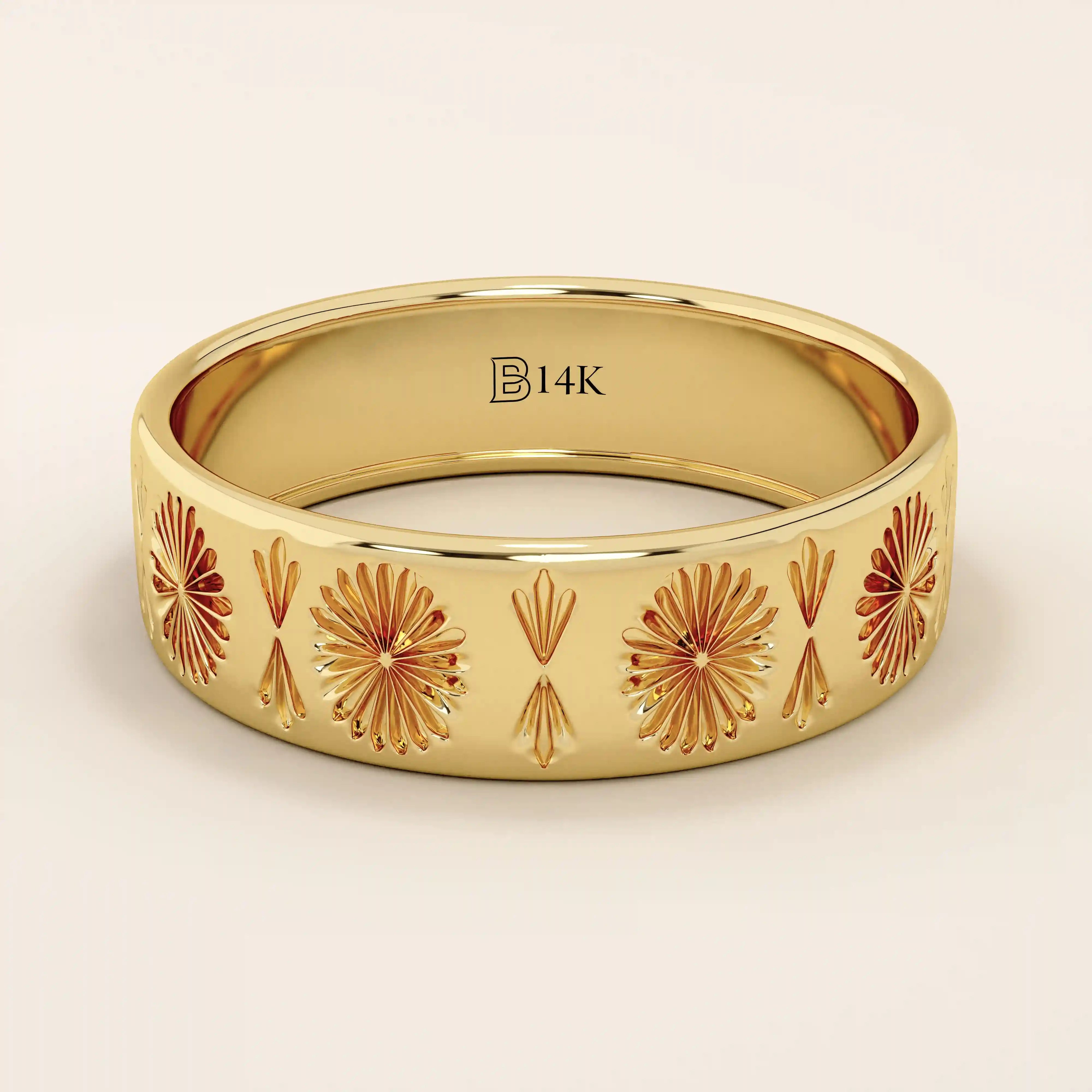 14k solid yellow gold wide wedding band with intricate engraved floral and fan motifs in a repeating pattern
