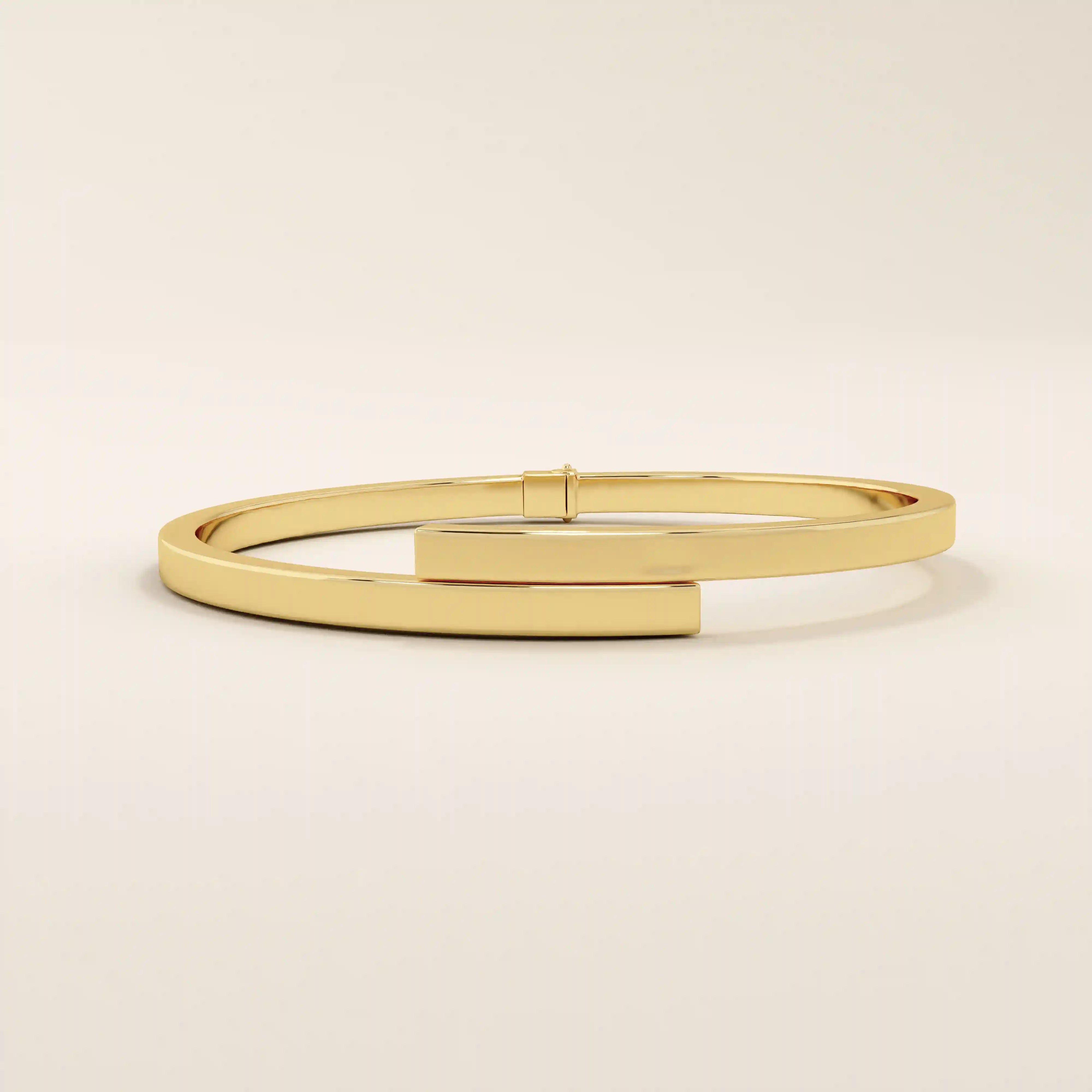14k solid yellow gold wrap-around bangle bracelet featuring a sleek overlapping design with a polished finish.
