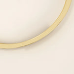 14k solid yellow gold wrap-around bangle bracelet featuring a sleek overlapping design with a polished finish.
