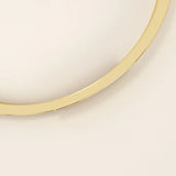 14k solid yellow gold wrap-around bangle bracelet featuring a sleek overlapping design with a polished finish.

