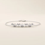 14k white gold baguette bar bracelet with rectangular baguette-cut stones and sparkling round stones in an elegant line design.
