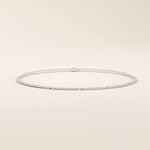 14k white gold bracelet featuring a curb link chain design with smooth round disc accents.
