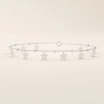 14k white gold bracelet featuring dangling star-shaped charms and textured bead details on a slim chain.
