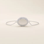 14k white gold bracelet with an oval centerpiece surrounded by pavé moissanite stones, crafted on a fine chain.
