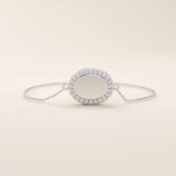 14k white gold bracelet with an oval centerpiece surrounded by pavé moissanite stones, crafted on a fine chain.
