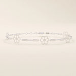 14k white gold bracelet with small flower motifs connected by slim chain links, crafted for a refined look.
