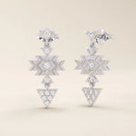 14k white gold geometric motif stud earrings with moissanite accents in star and triangle shapes, dangling design.
