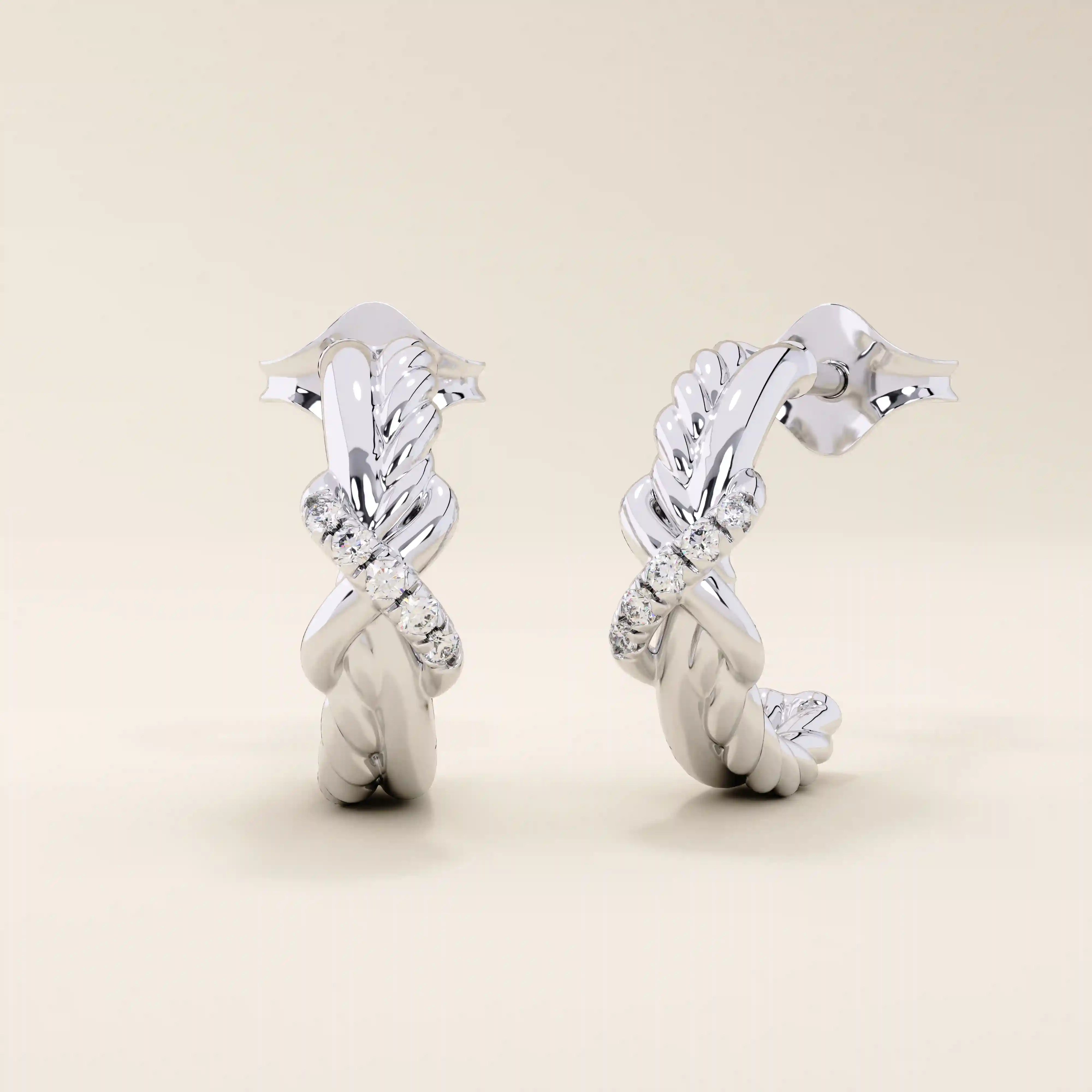 14k white gold knot stud earrings with interwoven polished and rope-textured strands accented by sparkling moissanites.

