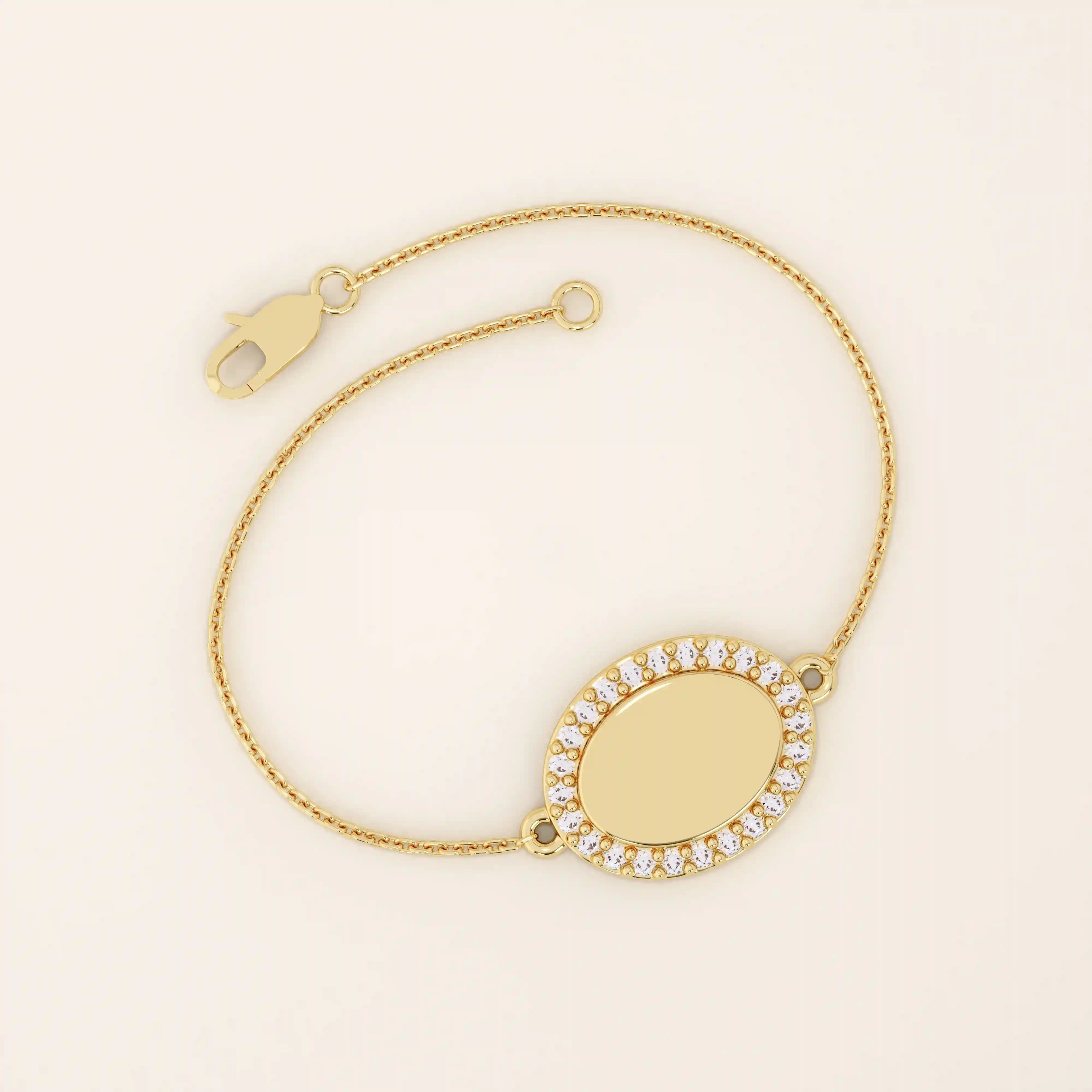14k yellow gold bracelet featuring an oval centerpiece framed with pavé moissanite stones on a delicate chain.
