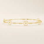 14k yellow gold bracelet featuring dainty flower-shaped charms linked together with delicate chain links.
