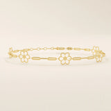 14k yellow gold bracelet featuring dainty flower-shaped charms linked together with delicate chain links.
