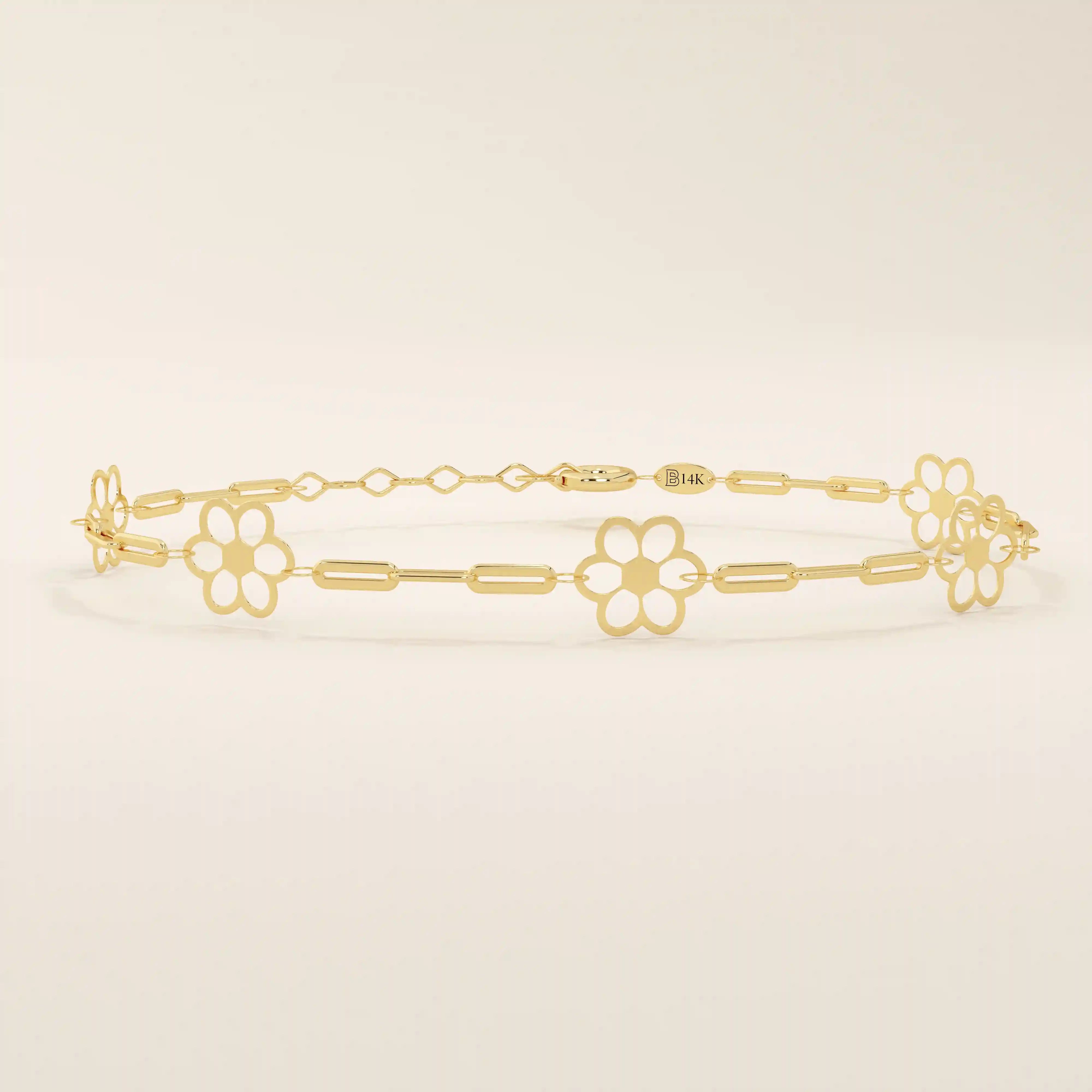 14k yellow gold bracelet featuring dainty flower-shaped charms linked together with delicate chain links.
