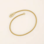 14k yellow gold bracelet with a delicate wheat chain design, polished and elegant.
