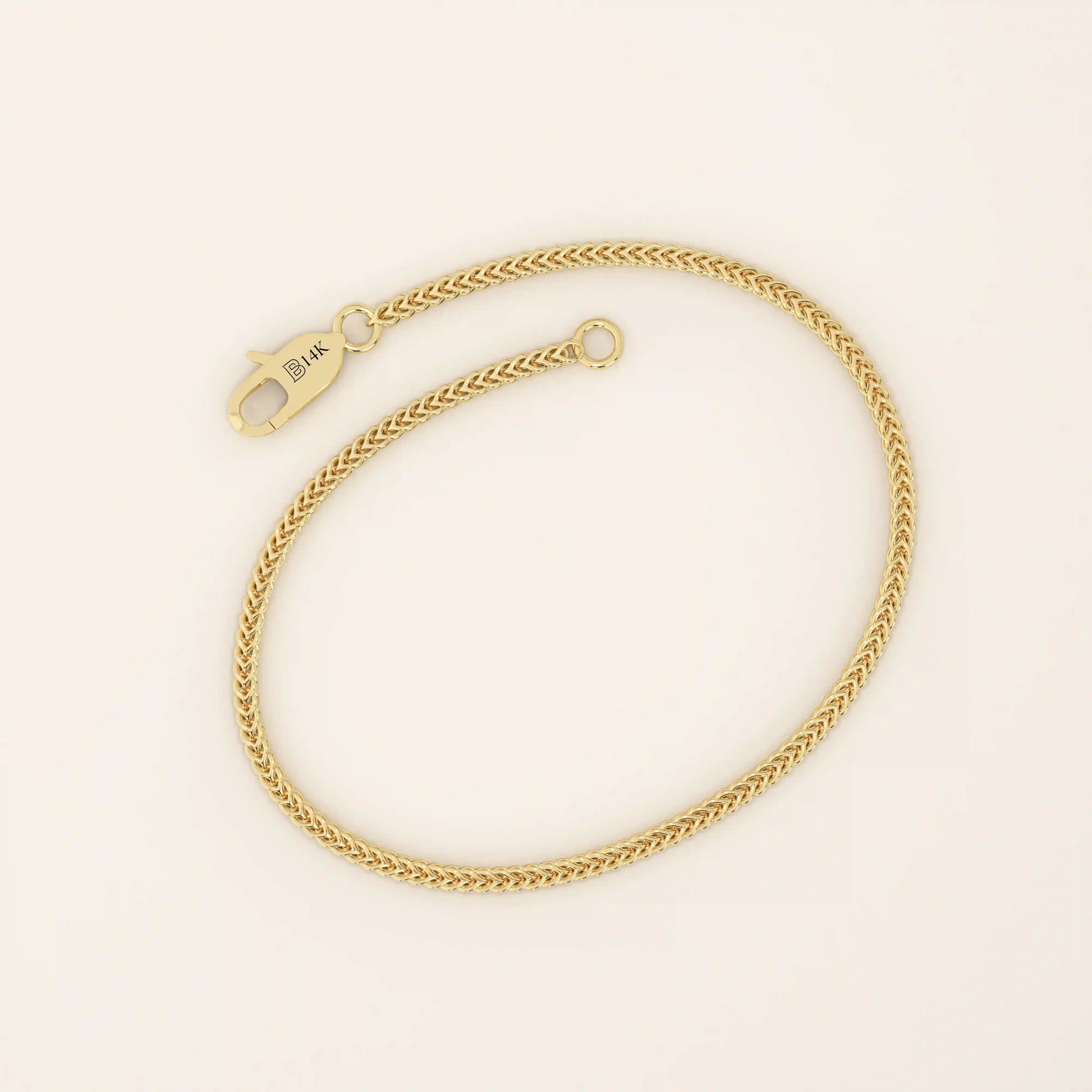 14k yellow gold bracelet with a delicate wheat chain design, polished and elegant.
