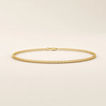 14k yellow gold bracelet with a delicate wheat chain design, polished and elegant.
