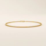 14k yellow gold bracelet with a delicate wheat chain design, polished and elegant.
