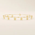14k yellow gold bracelet with dangling star charms and delicate twisted bead accents along a fine chain.
