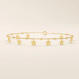 14k yellow gold bracelet with dangling star charms and delicate twisted bead accents along a fine chain.
