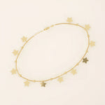 14k yellow gold bracelet with dangling star charms and delicate twisted bead accents along a fine chain.
